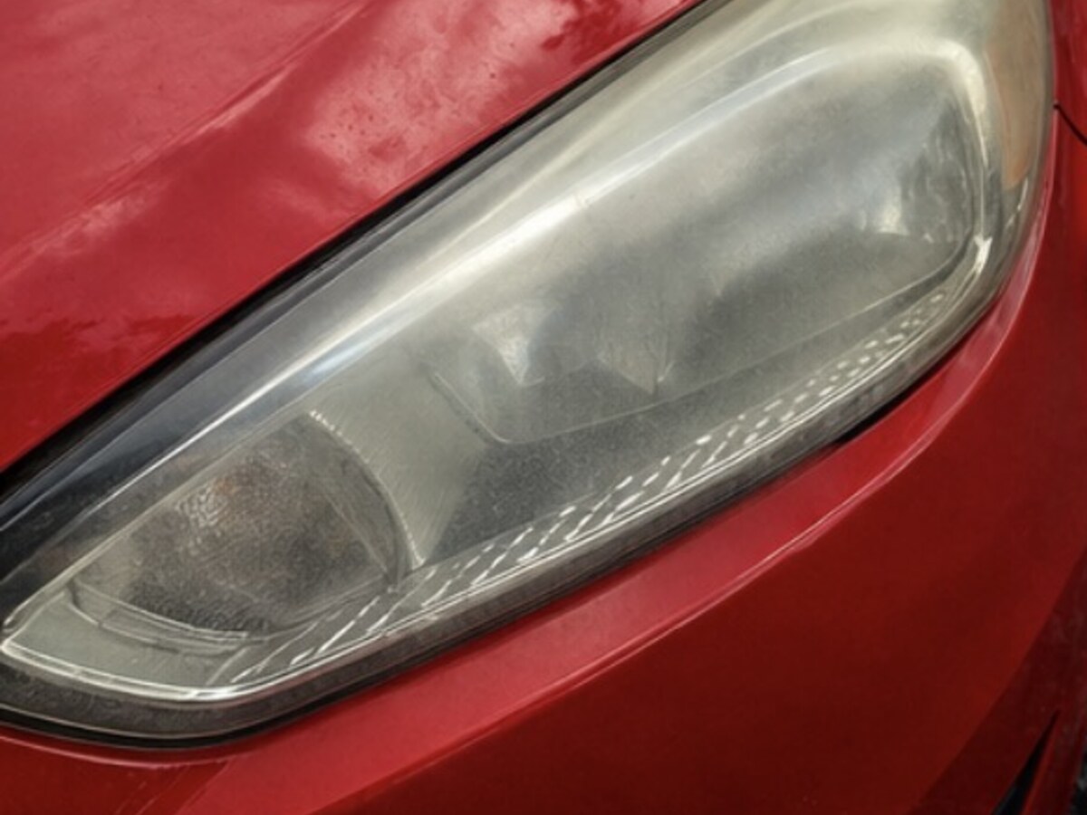 Cloudy oxidized headlight before professional restoration
