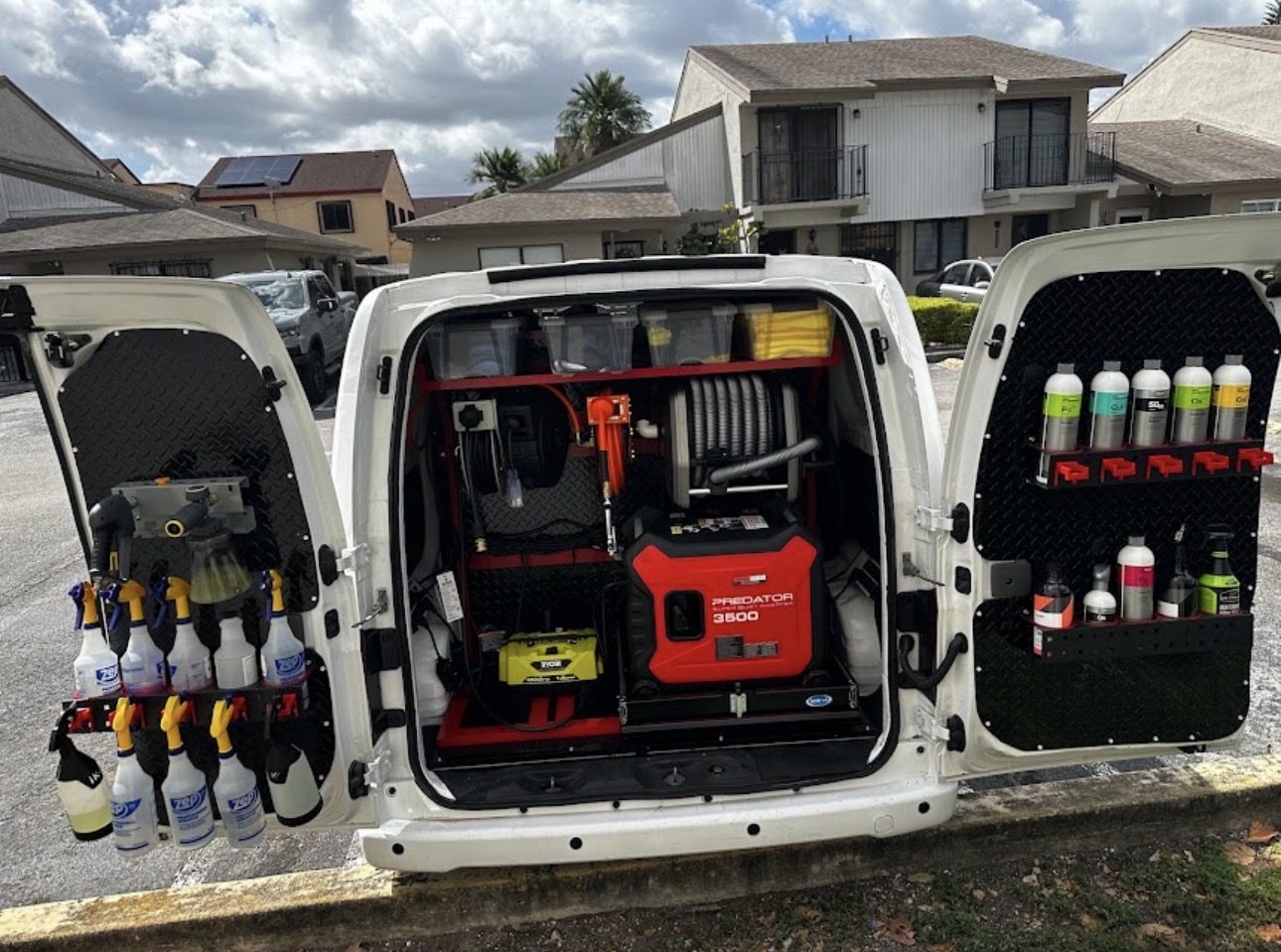 The Eduar Mobile Auto Detailing van open at the back, showing a generator, pressure hose reel and racked detailing products